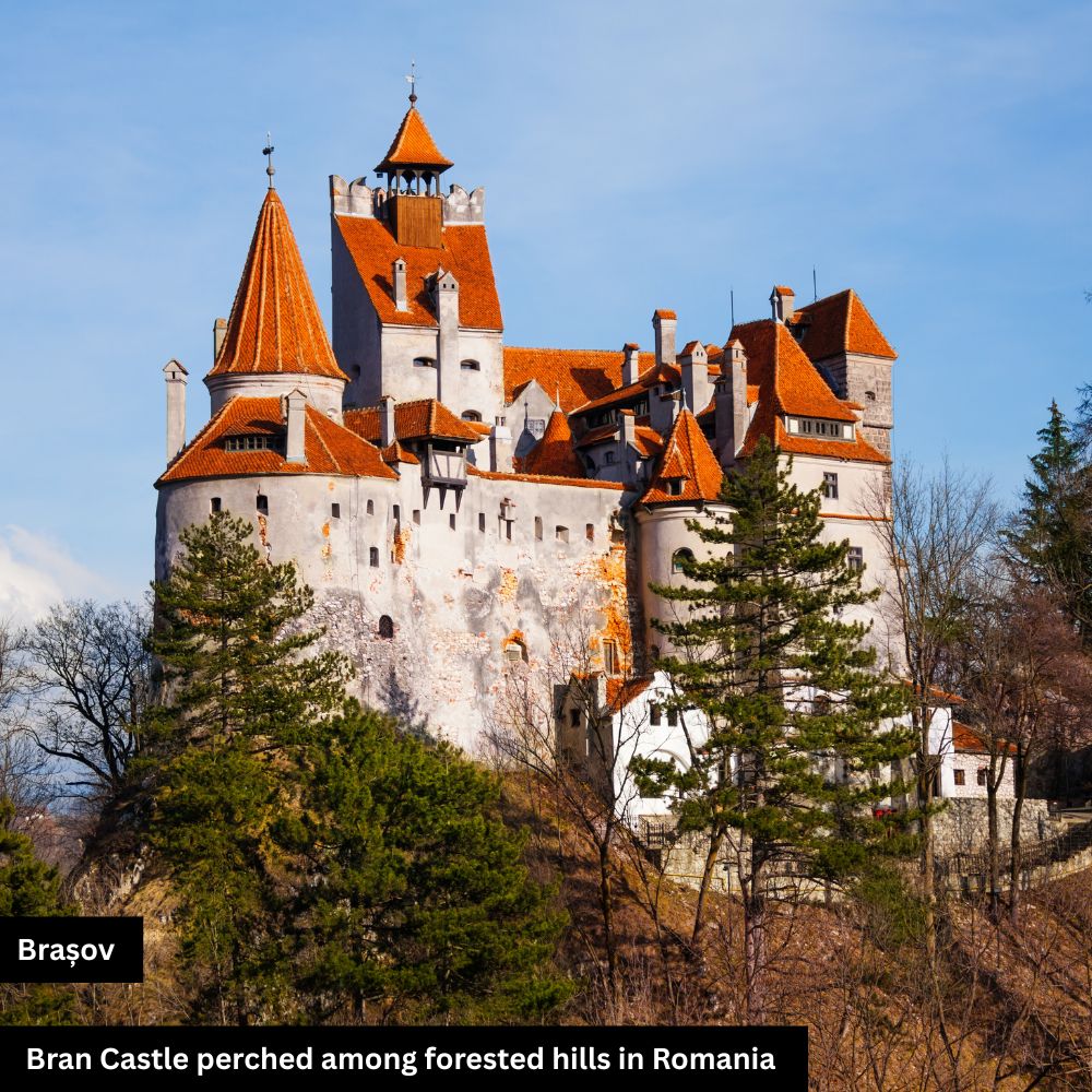 A stunning view of Bran Castle in Romania, perched on a rocky hilltop surrounded by lush greenery and dramatic skies, famously linked to the Dracula legend