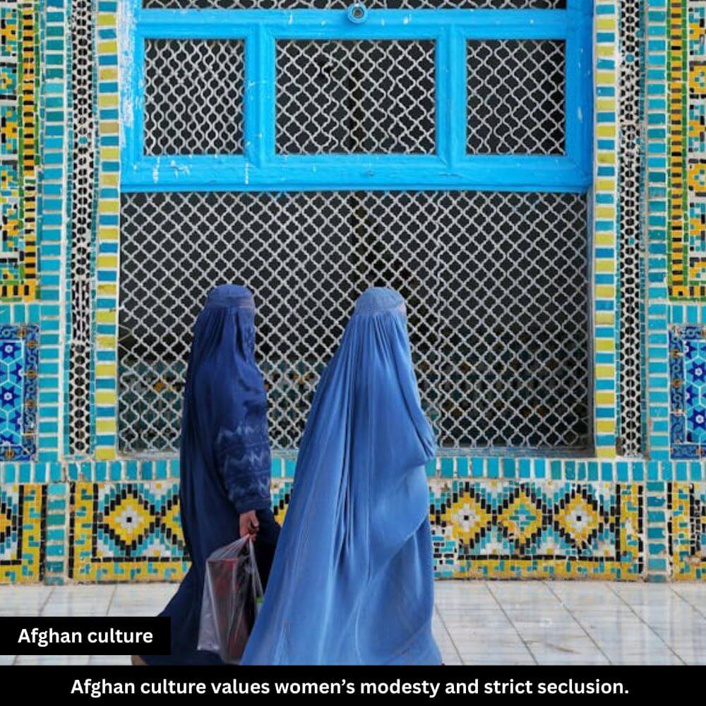 Two women in burqas walk quiet streets.