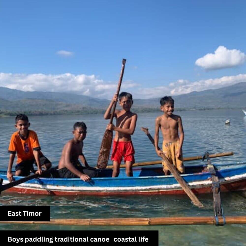 boys paddling traditional canoes