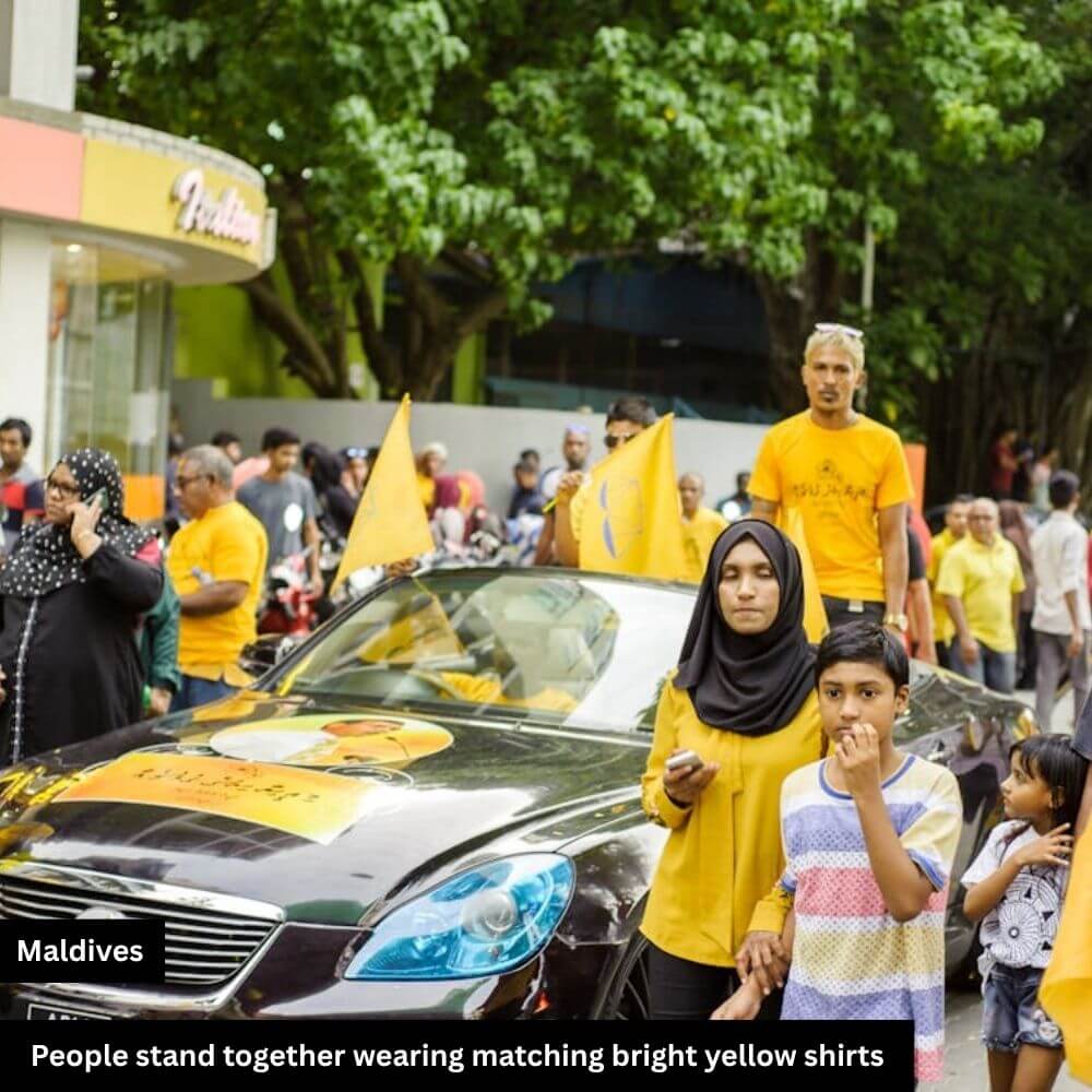 People stand wearing match yellow shirts