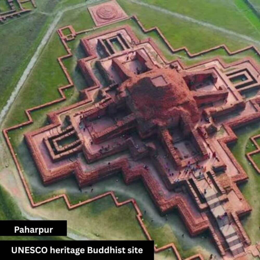 A historic view of the Paharpur Buddhist site, one of the largest monasteries in South Asia. The ancient brick structures stand tall with detailed ruins showcasing Buddhist architecture. The surrounding open grounds highlight the cultural and spiritual heritage of Bangladesh.