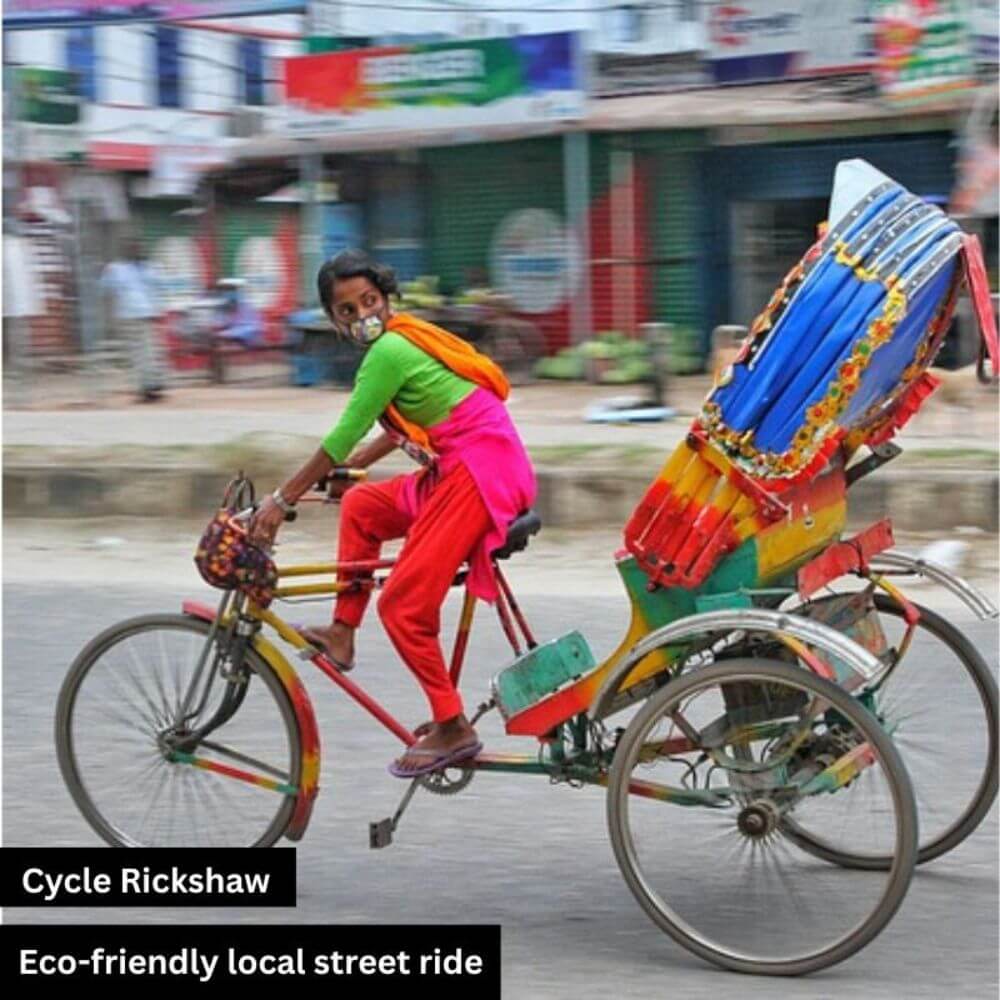 A woman rides a three-wheeled cycle rickshaw on a busy road, glancing back as if someone is calling her. She is wearing a red shalwar with a red and green kameez, reflecting traditional South Asian attire. The moment captures daily urban life and the cultural charm of local transport.